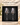 Two stemmed wine glasses held in fitted charcoal foam inside a black magnetic gift box.