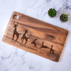 Engraved wood block cutting board. The engraving is on the front and towards the lower bottom part of the board. The engraving is of a family of deer lined in a row. There is a dad deer, mom deer and three kids. Under each deer has a printed name "Dad, Mama, Jameson, Anya, Brian". Deer can be added or taken away.