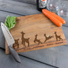 Engraved wood block cutting board. The engraving is on the front and towards the lower bottom part of the board. The engraving is of a family of deer lined in a row. There is a dad deer, mom deer and three kids. Under each deer has a printed name "Dad, Mama, Jameson, Anya, Brian". Deer can be added or taken away.