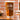Pint glass on a table. The glass has a design centered etched in the glass. The design is of different desert cactus plants and below is two lines, and between the lines it says the name "Amanda" in cursive and below the name is "BRIDESMAID" in all caps printed font. 